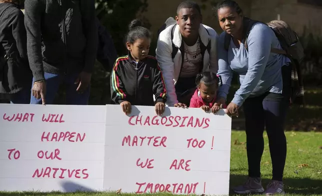 Chagossians Marie Michele, right, attends a protest to respond to the U.K. announcement agreeing to hand sovereignty of the long-contested Chagos Islands to Mauritius and against their "Exclusion" from Chagos negotiations, outside the House of Parliament, in London, Monday, Oct. 7, 2024. (AP Photo/Kin Cheung)