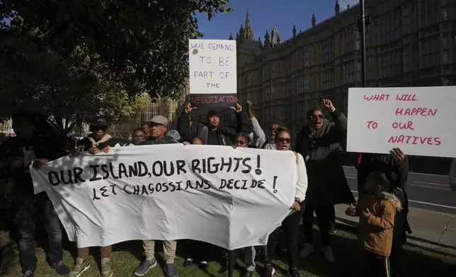 Chagossians attend a protest to respond to the U.K. announcement agreeing to hand sovereignty of the long-contested Chagos Islands to Mauritius and against their "Exclusion" from Chagos negotiations, outside the House of Parliament, in London, Monday, Oct. 7, 2024. (AP Photo/Kin Cheung)