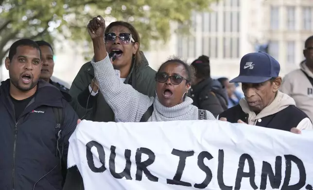 Chagossians attend a protest to response the U.K. announcement to agree to hand sovereignty of the long-contested Chagos Islands to Mauritius and against their "Exclusion" from Chagos negotiations, outside the House of Parliament, in London, Monday, Oct. 7, 2024. (AP Photo/Kin Cheung)