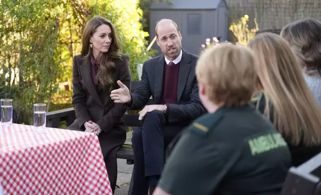 Britain's Prince William and Kate, Princess of Wales, speak to members of the emergency services during a visit to Southport Community Centre to meet rescue workers and the families of those caught up in the Southport knife attack earlier this year in Southport, England, Thursday, Oct. 10, 2024. (Danny Lawson, Pool Photo via AP)