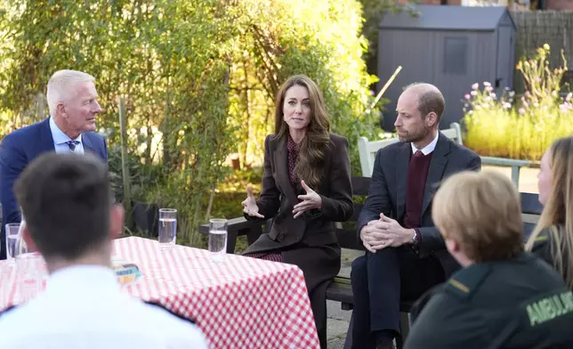 Britain's Prince William and Kate, Princess of Wales, speak to members of the emergency services during a visit to Southport Community Centre to meet rescue workers and the families of those caught up in the Southport knife attack earlier this year in Southport, England, Thursday, Oct. 10, 2024. (Danny Lawson, Pool Photo via AP)