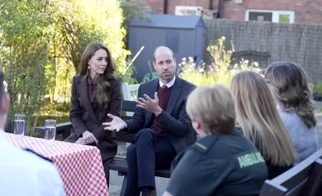 Britain's Prince William and Kate, Princess of Wales, speak to members of the emergency services during a visit to Southport Community Centre to meet rescue workers and the families of those caught up in the Southport knife attack earlier this year, in Southport, England, Thursday, Oct. 10, 2024. (Danny Lawson, Pool Photo via AP)