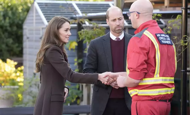 Britain's Prince William and Kate, Princess of Wales, meet a critical paramedic during a visit to Southport Community Centre to meet rescue workers and the families of those caught up in the Southport knife attack earlier this year in Southport, England, Thursday, Oct. 10, 2024. (Danny Lawson, Pool Photo via AP)