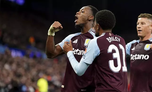 Aston Villa's Jhon Duran, left, celebrates scoring his sides second goal during the Champions League opening phase soccer match between Aston Villa and Bologna at the Villa Park in Birmingham, England, Tuesday, Oct. 22, 2024. (David Davies/PA via AP)