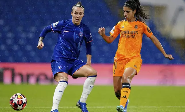 Chelsea's Lucy Bronze, left, and Real Madrid's Alba Redondo, right, challenge for the ball during the women's Champions League group B soccer match between FC Chelsea and Real Madrid in London, England, Tuesday, Oct. 8, 2024. (Zac Goodwin/PA via AP)