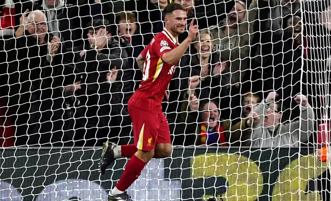 Liverpool's Alexis Mac Allister celebrates after scoring the opening goal during the Champions League opening phase soccer match between Liverpool and Bologna at the Anfield stadium in Liverpool, England, Wednesday, Oct. 2, 2024. (Peter Byrne/PA via AP)