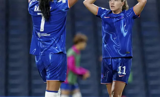 Chelsea's scorer Mayra Ramirez and her teammate Guro Reiten, right, celebrate their side's thirrd goal during the women's Champions League group B soccer match between FC Chelsea and Real Madrid in London, England, Tuesday, Oct. 8, 2024. (Zac Goodwin/PA via AP)