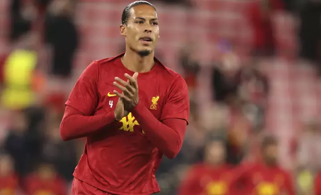 Liverpool's Virgil van Dijk warms up prior to the Champions League soccer match between Liverpool and Bologna at the Anfield stadium in Liverpool, England, Wednesday, Oct. 2, 2024. (AP Photo/Ian Hodgson)