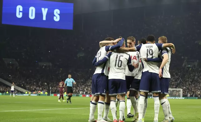 Tottenham's Timo Werner celebrates with teammates after scoring his side's opening goal during the English League Cup fourth round soccer match between Tottenham and Manchester City, at the Tottenham Hotspur Stadium in London, Wednesday, Oct 30, 2024. (AP Photo/Ian Walton)