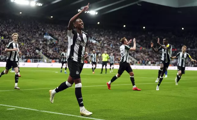 Newcastle United's Joe Willock celebrates an own goal by Chelsea's Axel Disasi during the English League Cup fourth round soccer match between Newcastle United and Chelsea at St James' Park, Newcastle, England, Wednesday Oct. 30, 2024. (Owen Humphreys/PA via AP)