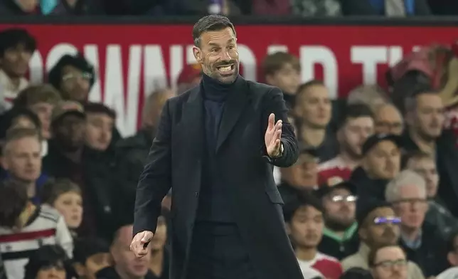 Manchester United's head coach Ruud van Nistelrooij gives instructions during the English League Cup soccer match between Manchester United and Leicester City at the Old Trafford stadium in Manchester, England, Wednesday, Oct. 30, 2024. (AP Photo/Dave Thompson)