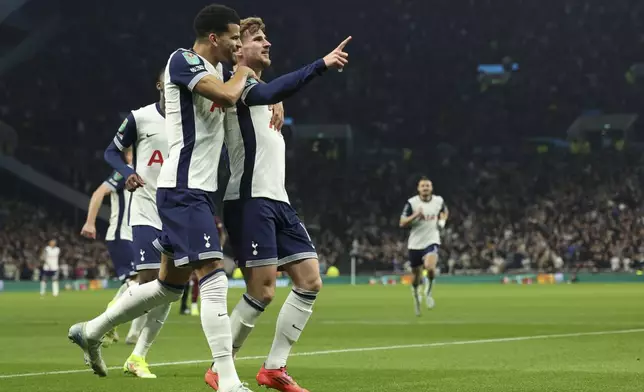 Tottenham's Timo Werner celebrates with teammates after scoring his side's opening goal during the English League Cup fourth round soccer match between Tottenham and Manchester City, at the Tottenham Hotspur Stadium in London, Wednesday, Oct 30, 2024. (AP Photo/Ian Walton)