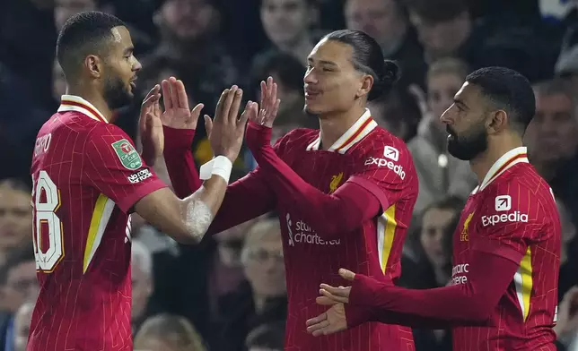 Liverpool's Cody Gakpo, left, celebrates after scoring his second goal against Brighton during the English League Cup soccer match between Brighton and Liverpool at Falmer Stadium in Brighton, England, Wednesday, Oct. 30, 2024. (AP Photo/Dave Shopland)