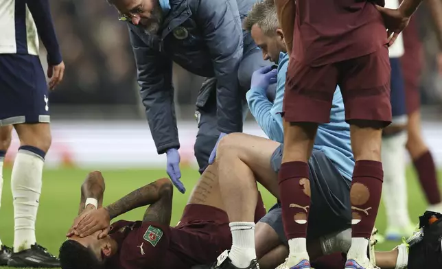 Manchester City's Savinho reacts after sustaining an injury during the English League Cup fourth round soccer match between Tottenham and Manchester City, at the Tottenham Hotspur Stadium in London, Wednesday, Oct 30, 2024. (AP Photo/Ian Walton)