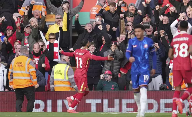 Liverpool's Mohamed Salah, centre, celebrates after scoring his side's opening goal during the English Premier League soccer match between Liverpool and Chelsea at Anfield Stadium, Liverpool, England, Sunday, Oct. 20, 2024. (AP Photo/Jon Super)