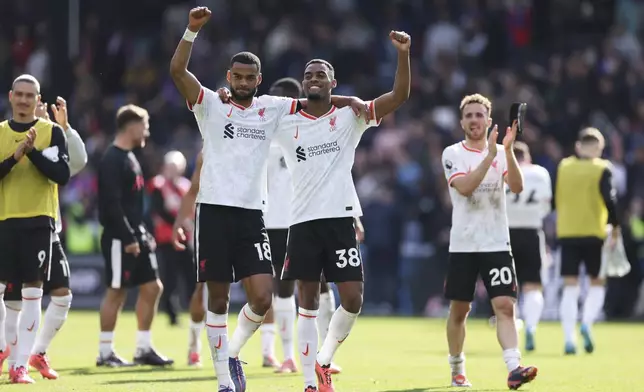 Liverpool's Cody Gakpo, centre left, Ryan Gravenberch, centre, and Diogo Jota celebrate after the English Premier League soccer match between Crystal Palace and Liverpool at Selhurst Park in London, Saturday, Oct. 5, 2024.(AP Photo/Ian Walton)