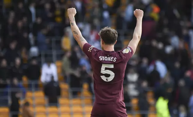 Manchester City's John Stones celebrates after the VAR confirmed his side's second goal during the English Premier League soccer match between Wolverhampton Wanderers and Manchester City at the Molineux Stadium in Wolverhampton, England, Sunday, Oct. 20, 2024. (AP Photo/Rui Vieira)