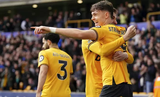 Wolverhampton Wanderers' Jorgen Strand Larsen, right, celebrates scoring with teammates during the English Premier League soccer match between Wolverhampton Wanderers and Manchester City at Molineux Stadium, Wolverhampton, England, Sunday Oct. 20, 2024. (David Davies/PA via AP)