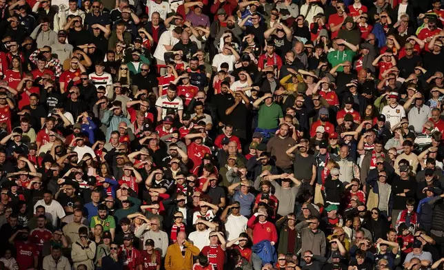 Fans watch from the stands during the English Premier League soccer match between Manchester United and Brentford at Old Trafford stadium in Manchester, England, Saturday, Oct. 19, 2024. (AP Photo/Dave Thompson)