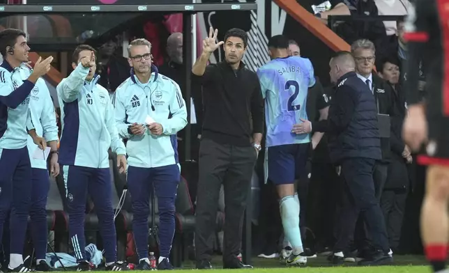 Arsenal's manager Mikel Arteta gives instructions from the side line as Arsenal's William Saliba, centre right, leaves the pitch after receiving the red card during the English Premier League soccer match between Bournemouth and Arsenal at the Vitality Stadium in Bournemouth, England, Saturday, Oct. 19, 2024. (AP Photo/Kin Cheung)