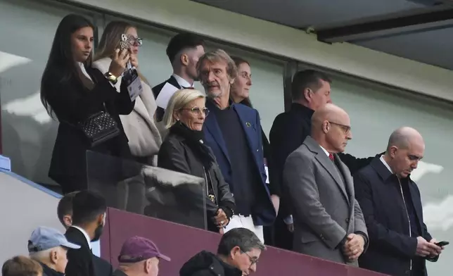 Manchester United owner Sir Jim Ratcliffe, center, looks out from the stands prior the English Premier League soccer match between Aston Villa and Manchester United, at Villa Park in Birmingham, England, Sunday, Oct. 6, 2024. (AP Photo/Rui Vieira)