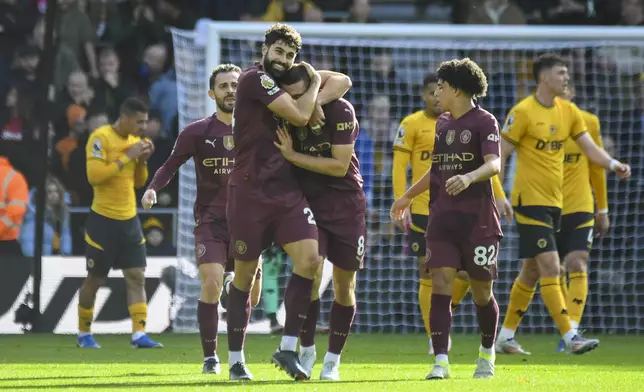 Manchester City's Josko Gvardio is congratulated by Mateo Kovacic after scoring his side's first goal during the English Premier League soccer match between Wolverhampton Wanderers and Manchester City at the Molineux Stadium in Wolverhampton, England, Sunday, Oct. 20, 2024. (AP Photo/Rui Vieira)