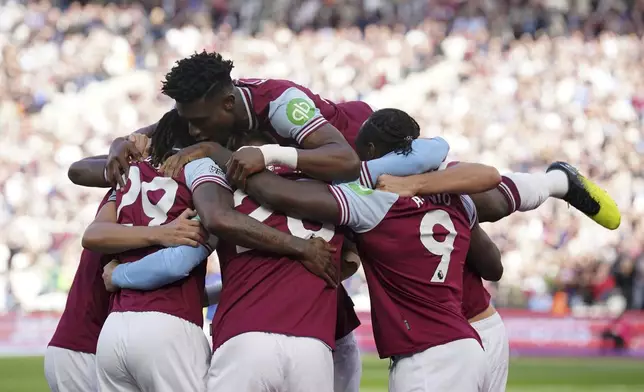 West Ham United's Michail Antonio, right, celebrates scoring their side's first goal of the game during the Premier League match between West Ham United and Ipswich at the London Stadium, Saturday Oct. 5, 2024. (Jonathan Brady/PA via AP)