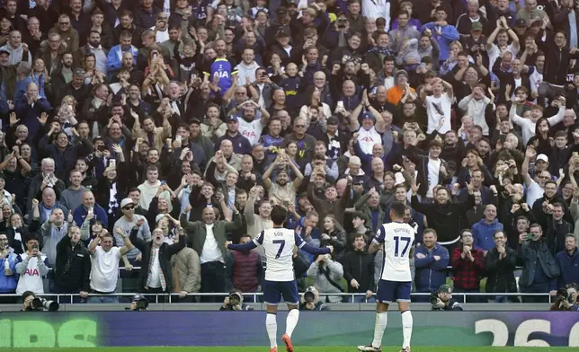 Tottenham Hotspur's Son Heung-Min, left, celebrates scoring with fans during the English Premier League soccer match between Tottenham Hotspur and West Ham United at the Tottenham Hotspur Stadium, London, Saturday Oct. 19, 2024. (Zac Goodwin/PA via AP)