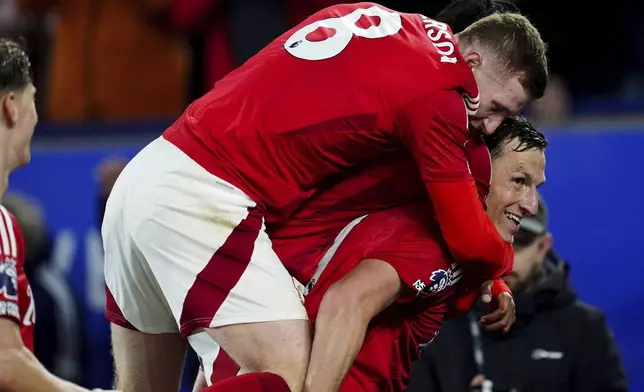 Nottingham Forest's Chris Wood, right, celebrates scoring their side's second goal of the game during the Premier League match at the King Power Stadium, in Leicester, England, Friday Oct. 25, 2024. (Mike Egerton/PA via AP)