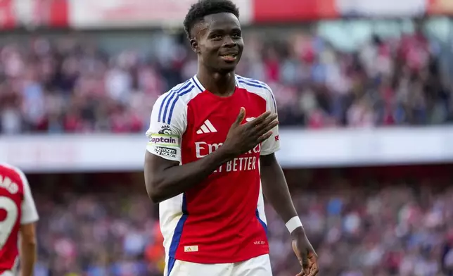 Arsenal's Bukayo Saka celebrates after scoring his side's third goal during the English Premier League soccer match between Arsenal and Southampton at the Emirates Stadium in London, Saturday, Oct. 5, 2024. (AP Photo/Kirsty Wigglesworth)