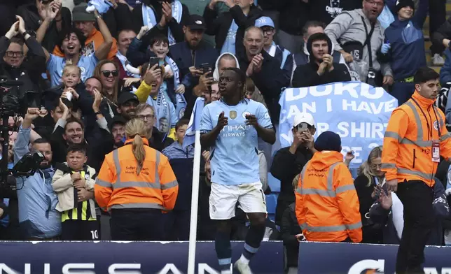 Manchester City's Jeremy Doku celebrates after scoring his side's third goal during the English Premier League soccer match between Manchester City and Fulham at Etihad Stadium in Manchester, England, Saturday, Oct. 5, 2023. (AP Photo/Darren Staples)