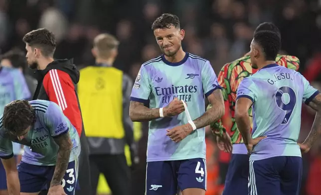 Arsenal's Ben White, centre, reacts disappointed after the English Premier League soccer match between Bournemouth and Arsenal at the Vitality Stadium in Bournemouth, England, Saturday, Oct. 19, 2024. (AP Photo/Kin Cheung)