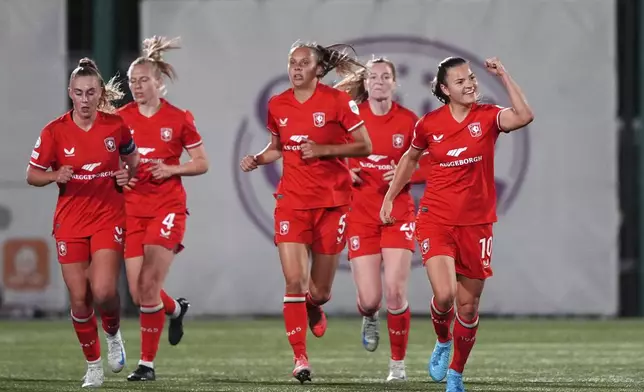 FC Twente's Kayleigh van Dooren, right, celebrates scoring their side's first goal of the game during the UEFA Women's Champions League group stage match between Celtic and Twente at New Douglas Park, Hamilton, Britain, Tuesday Oct. 8, 2024. (Andrew Milligan/PA via AP)