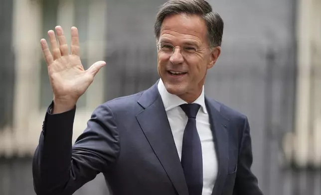 NATO Secretary General Mark Rutte waves to the media after a meeting with Britain's Prime Minister Keir Starmer and Ukrainian President Volodymyr Zelenskyy at 10 Downing Street in London, Thursday, Oct. 10, 2024.(AP Photo/Kin Cheung)