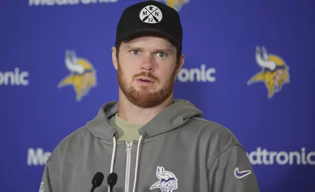 Minnesota Vikings quarterback Sam Darnold speaks during a news conference after NFL football practice at The Grove in Watford, England, Friday, Oct. 4, 2024. (AP Photo/Kin Cheung)