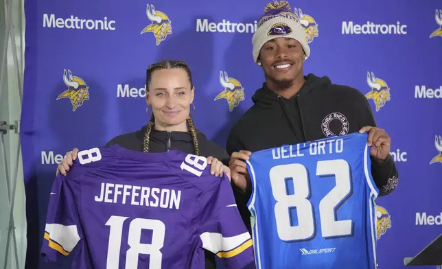 Minnesota Vikings wide receiver Justin Jefferson, right, poses with Nausicaa Dell'Orto, Captain of the Italian women's national flag football team, during a news conference after NFL football practice at The Grove in Watford, England, Friday, Oct. 4, 2024. (AP Photo/Kin Cheung)