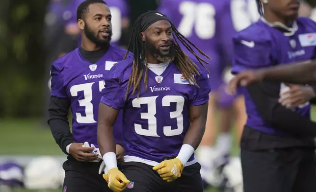 Minnesota Vikings running back Aaron Jones (33) works out during NFL football practice at The Grove in Watford, England Friday, Oct. 4, 2024. (AP Photo/Kin Cheung)