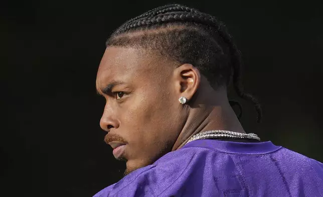 Minnesota Vikings wide receiver Justin Jefferson (18) looks on during NFL football practice at The Grove in Watford, England Friday, Oct. 4, 2024. (AP Photo/Kin Cheung)