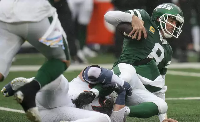 New York Jets quarterback Aaron Rodgers (8) is sacked by Denver Broncos defensive end Zach Allen (99) during the first quarter of an NFL football game, Sunday, Sept. 29, 2024, in East Rutherford, N.J. (AP Photo/Seth Wenig)