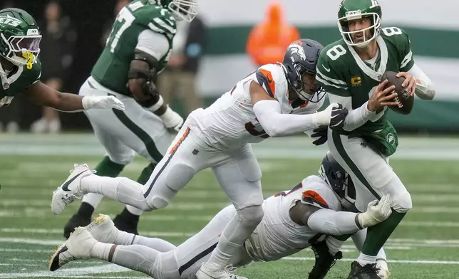 New York Jets quarterback Aaron Rodgers (8) is sacked by the Denver Broncos during the fourth quarter of an NFL football game, Sunday, Sept. 29, 2024, in East Rutherford, N.J. (AP Photo/Seth Wenig)