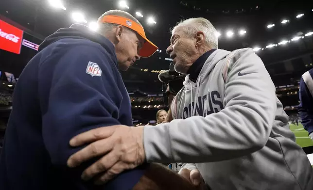 Denver Broncos head coach Sean Payton, left, greets his brother Tom Payton as he walks onto the field before an NFL football game against the New Orleans Saints, Thursday, Oct. 17, 2024, in New Orleans. (AP Photo/Gerald Herbert)