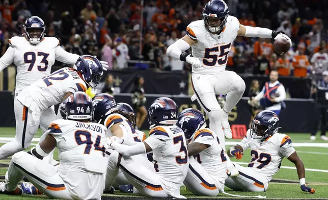 Denver Broncos linebacker Cody Barton (55) celebrates with teammates after returning a fumble for a touchdown during the second half of an NFL football game against the New Orleans Saints, Thursday, Oct. 17, 2024, in New Orleans. (AP Photo/Butch Dill)