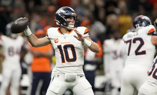 Denver Broncos quarterback Bo Nix throws a pass during the first half of an NFL football game against the New Orleans Saints, Thursday, Oct. 17, 2024, in New Orleans. (AP Photo/Gerald Herbert)