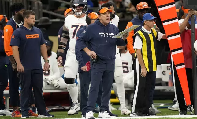 Denver Broncos head coach Sean Payton watches from the sideline during the first half of an NFL football game against the New Orleans Saints, Thursday, Oct. 17, 2024, in New Orleans. (AP Photo/Gerald Herbert)