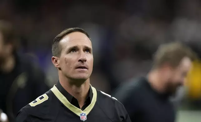 Former New Orleans Saints quarterback Drew Brews walks on the field before an NFL football game between the Saints and the Denver Broncos, Thursday, Oct. 17, 2024, in New Orleans. (AP Photo/Gerald Herbert)