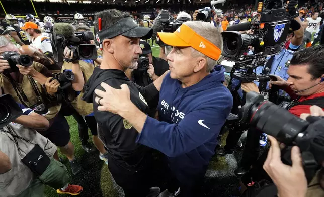 New Orleans Saints head coach Dennis Allen, left, talks with Denver Broncos head coach Sean Payton after an NFL football game, Thursday, Oct. 17, 2024, in New Orleans. The Broncos won 33-10. (AP Photo/Gerald Herbert)