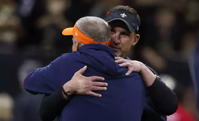 New Orleans Saints head coach Dennis Allen, right, hugs Denver Broncos head coach Sean Payton before an NFL football game, Thursday, Oct. 17, 2024, in New Orleans. (AP Photo/Butch Dill)