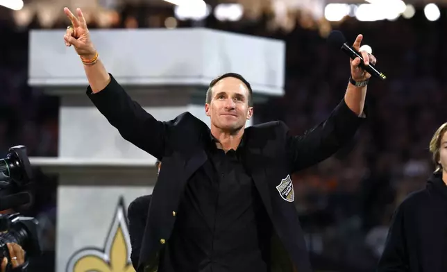 Former New Orleans Saints quarterback Drew Brees celebrates his induction in the Saints Hall of Fame during halftime of NFL football game between the Saints and the Denver Broncos, Thursday, Oct. 17, 2024, in New Orleans. (AP Photo/Butch Dill)