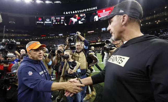 Denver Broncos head coach Sean Payton, left, greets New Orleans Saints head coach Dennis Allen after an NFL football game, Thursday, Oct. 17, 2024, in New Orleans. The Broncos won 33-10. (AP Photo/Butch Dill)