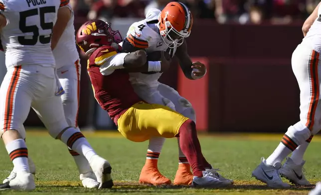 Cleveland Browns quarterback Deshaun Watson (4) is sacked by Washington Commanders linebacker Dante Fowler Jr. (6) during the second half of an NFL football game in Landover, Md., Sunday, Oct. 6, 2024. (AP Photo/Nick Wass)